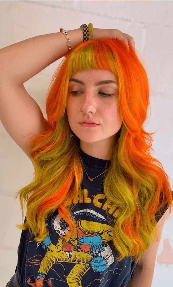 Blood orange and yellow vivid color with bold warm tones and curtain bangs
