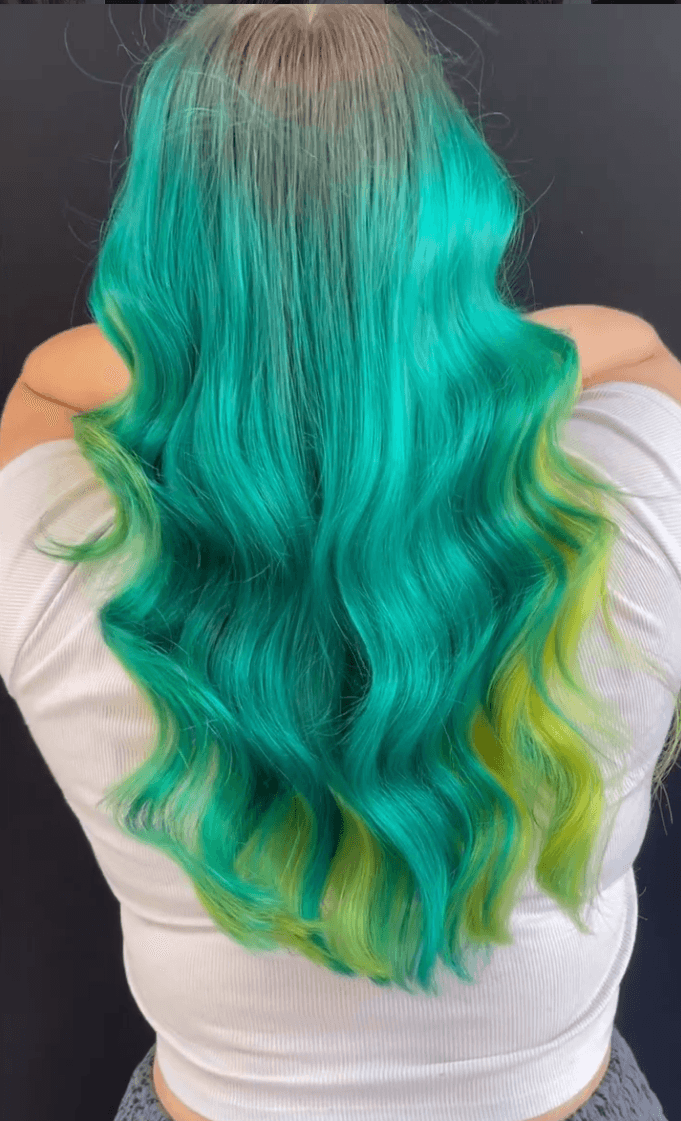 Vivid teal and emerald green color with yellow-green underlights on long flowing waves