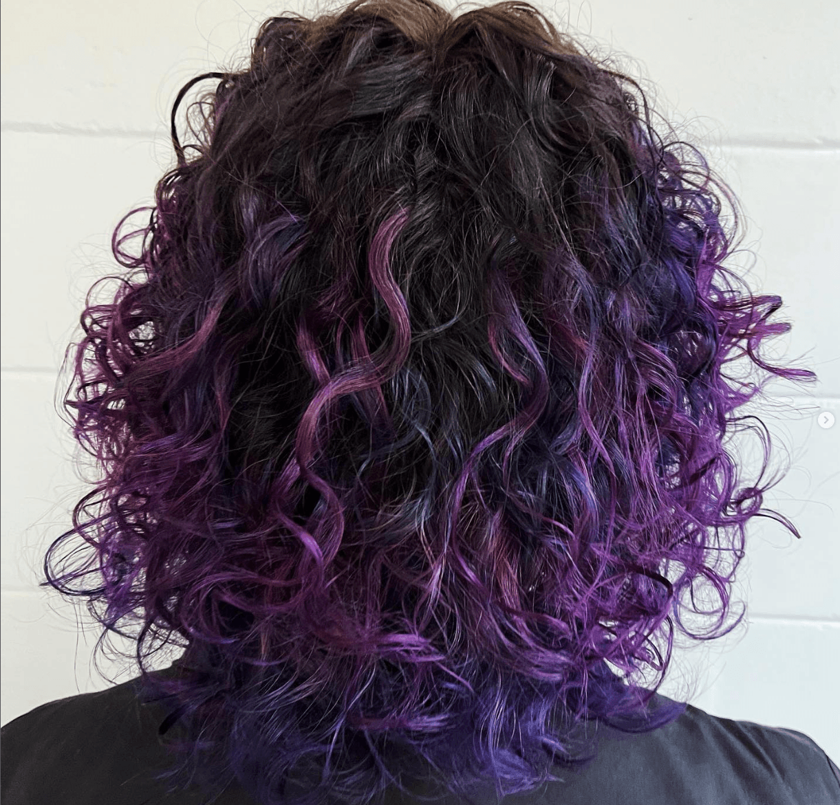 Rich purple and violet color on natural curly texture with dark root shadow